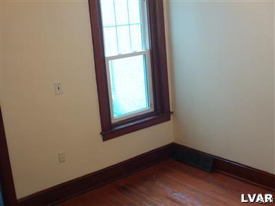 1019 Spring Street Bethlehem, PA 18018 - Photo 10 of 27 a view of an empty room with wooden floor and a window
