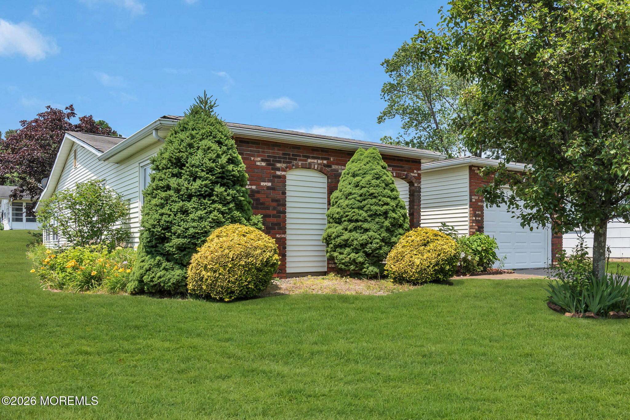 67 Blake Circle Brick, NJ 08724 - Photo 5 of 34 a front view of a house with a garden