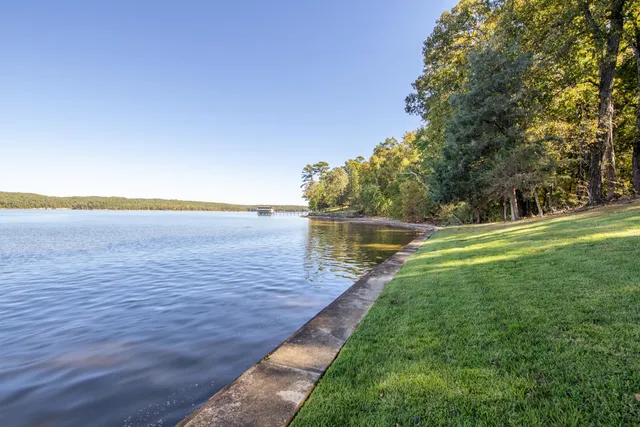 a view of a yard with wooden fence