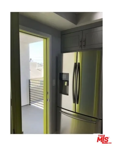 a kitchen with a refrigerator and cabinets