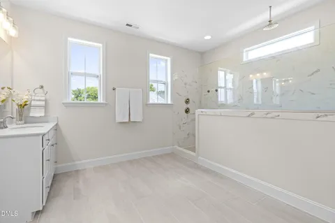 a bathroom with a double vanity sink and a mirror