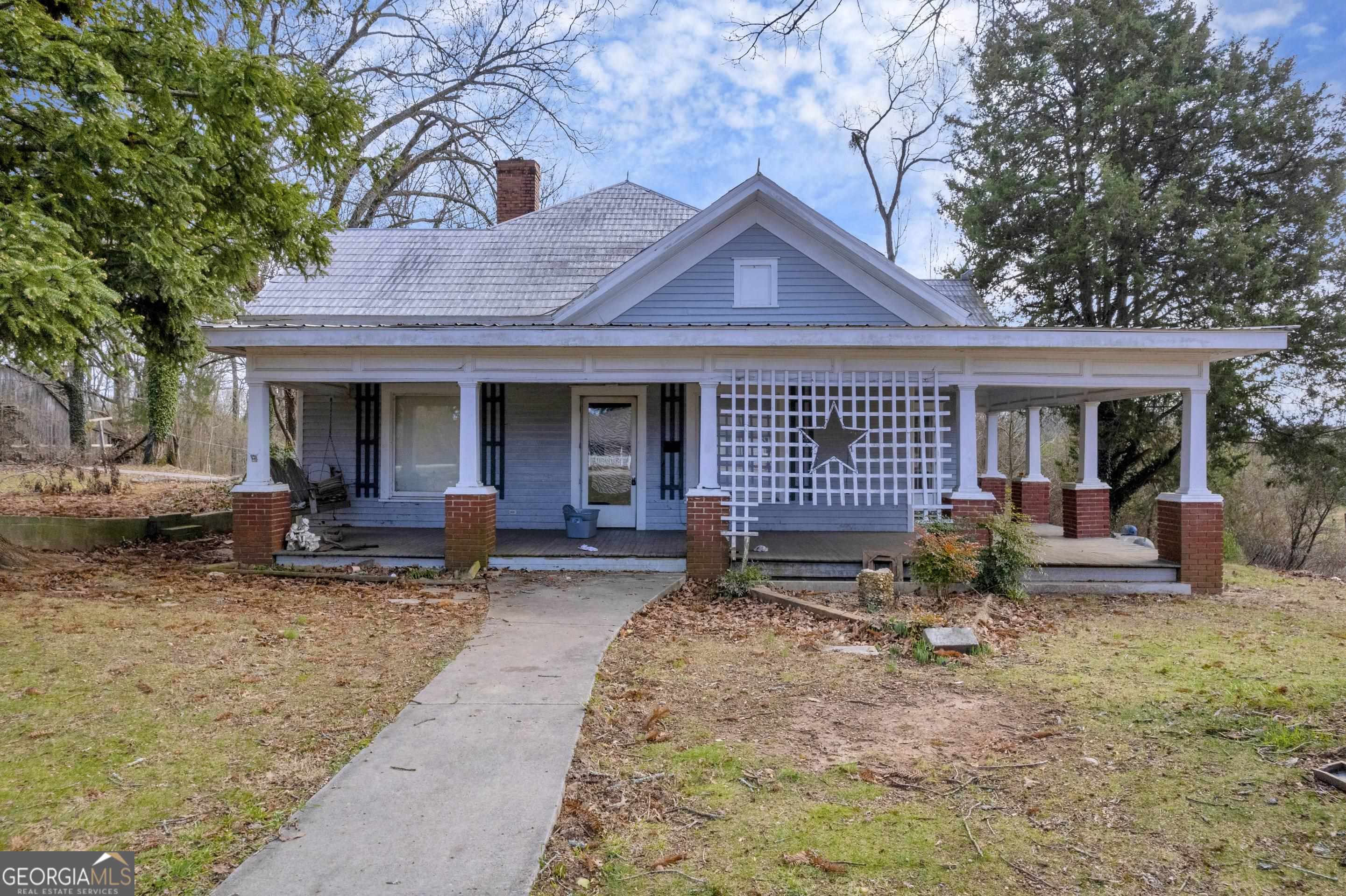 4160 Pea Ridge Road Cornelia, GA 30531 - Photo 1 of 1 a front view of a house with outdoor seating