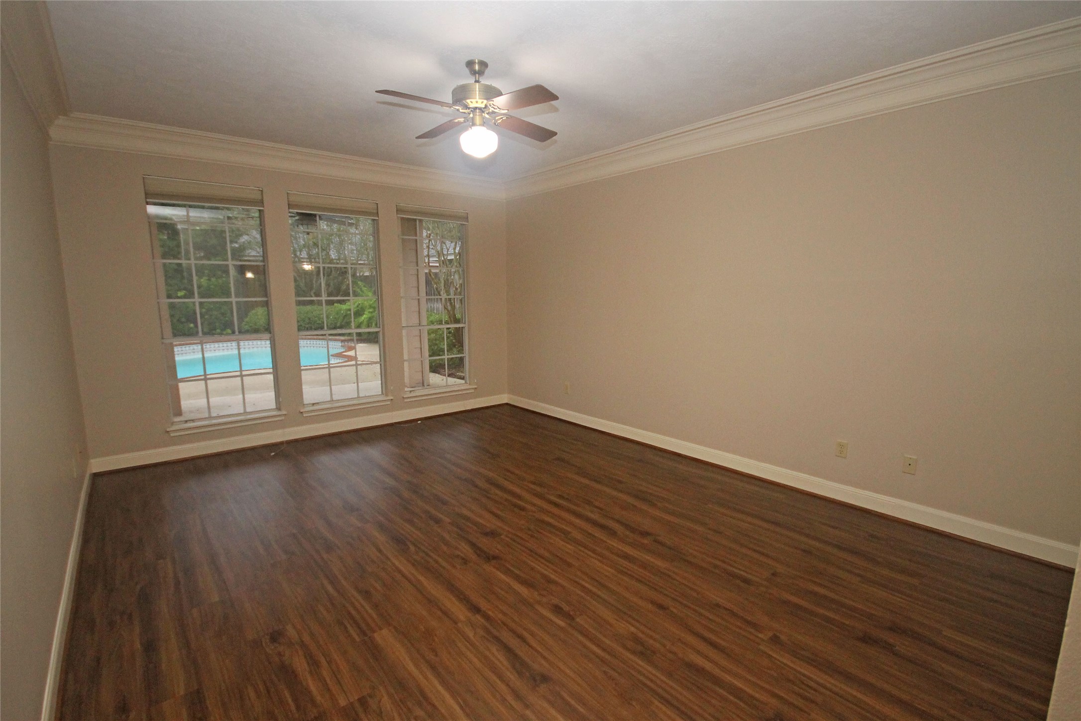 17703 Forest Park Lane Spring, TX 77379 - Photo 19 of 40 a view of an empty room with wooden floor and a window