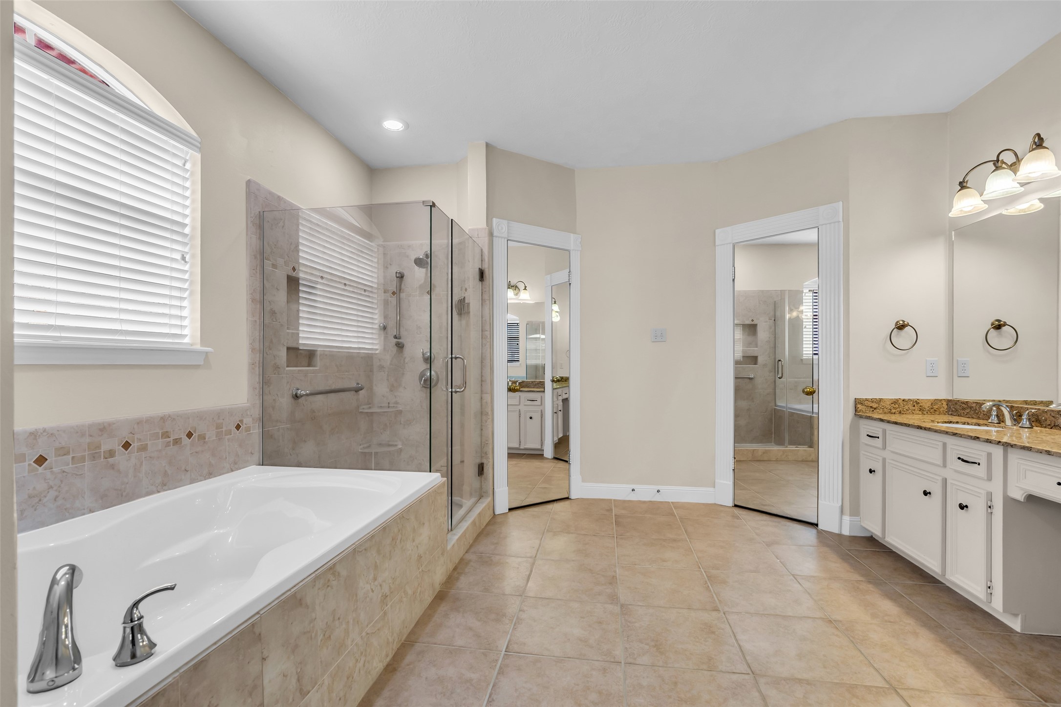 17703 Forest Park Lane Spring, TX 77379 - Photo 22 of 40 a spacious bathroom with a granite countertop tub shower double vanity and a sink
