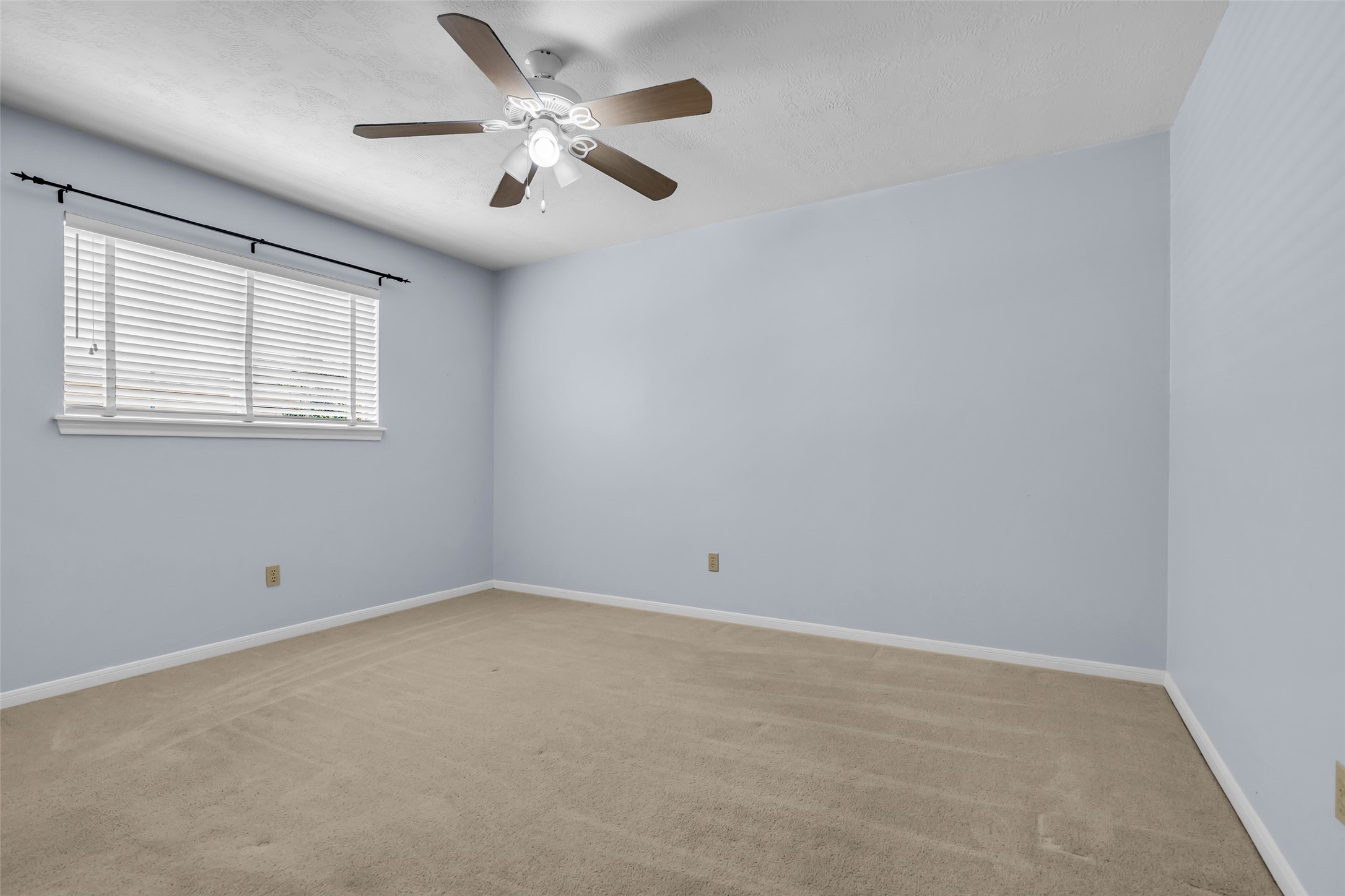 17703 Forest Park Lane Spring, TX 77379 - Photo 26 of 40 an empty room with a window and ceiling fan