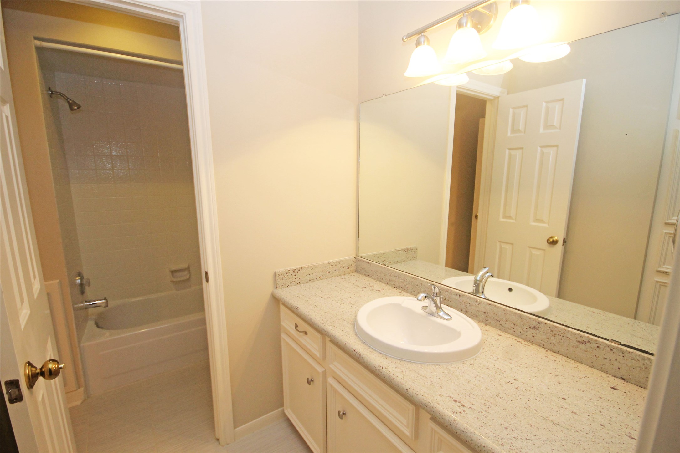 17703 Forest Park Lane Spring, TX 77379 - Photo 31 of 40 a bathroom with a granite countertop sink and a mirror