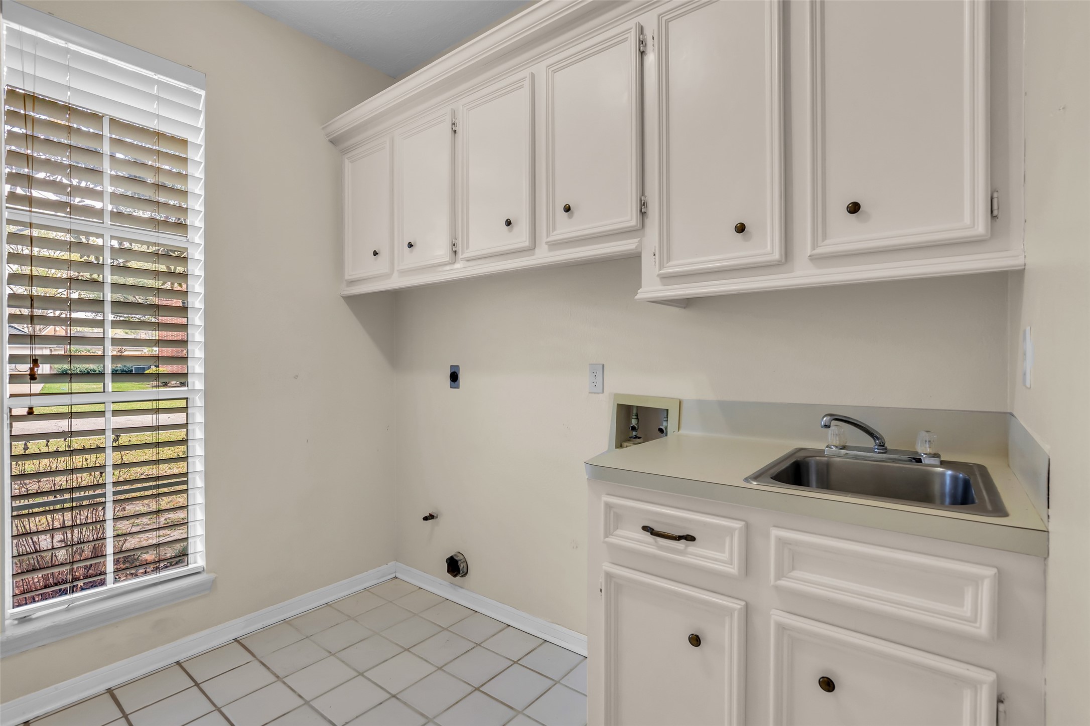 17703 Forest Park Lane Spring, TX 77379 - Photo 36 of 40 a kitchen with white cabinets and a sink