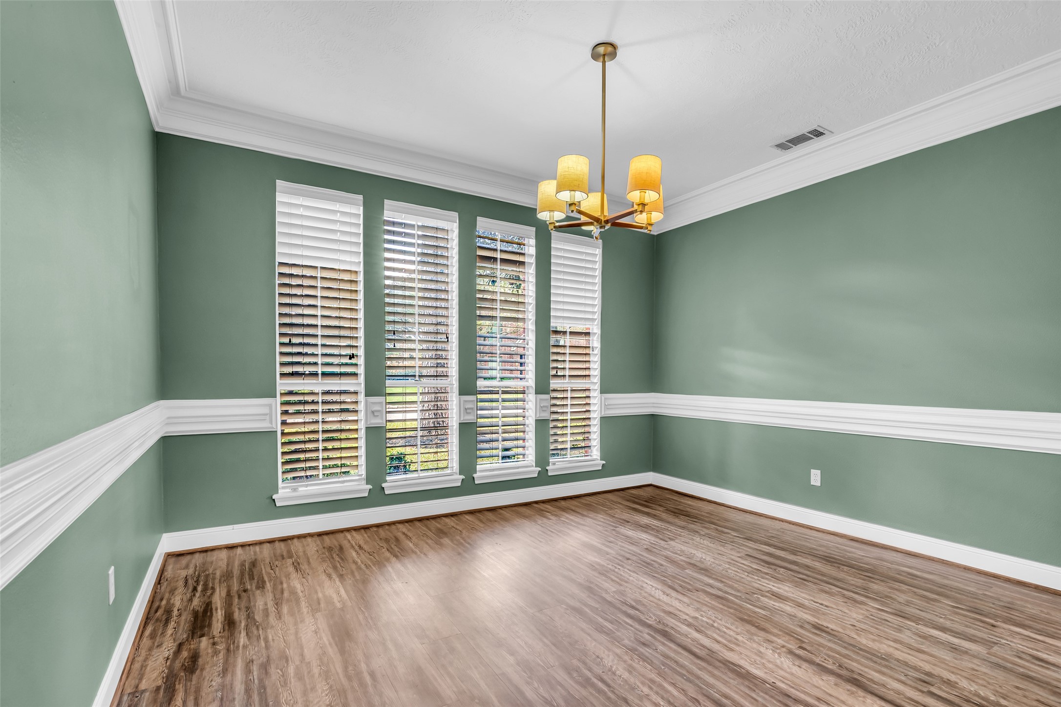 17703 Forest Park Lane Spring, TX 77379 - Photo 5 of 40 a view of a livingroom with a chandelier wooden floor and windows
