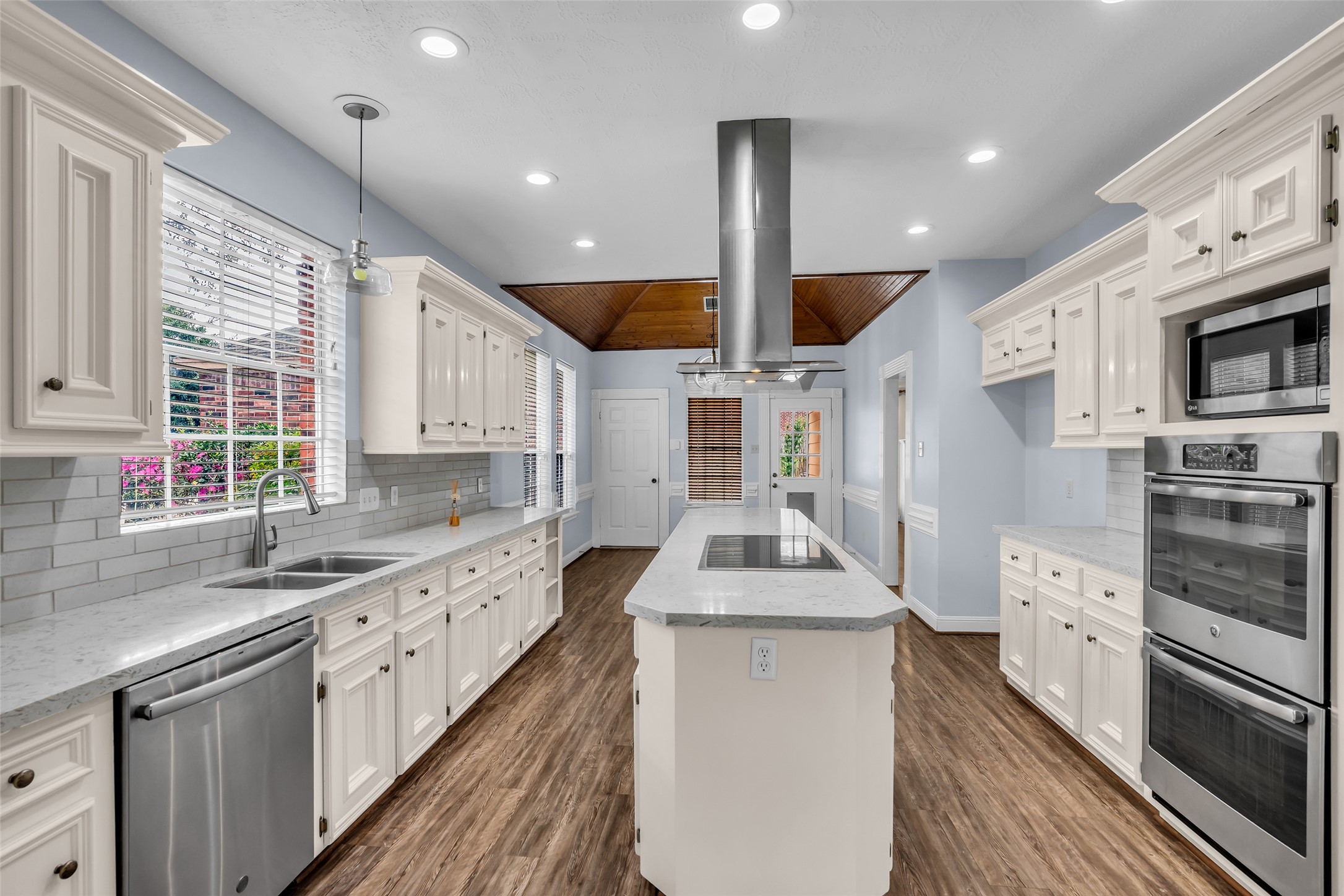 17703 Forest Park Lane Spring, TX 77379 - Photo 10 of 40 a kitchen with stainless steel appliances kitchen island granite countertop a sink a stove and cabinets