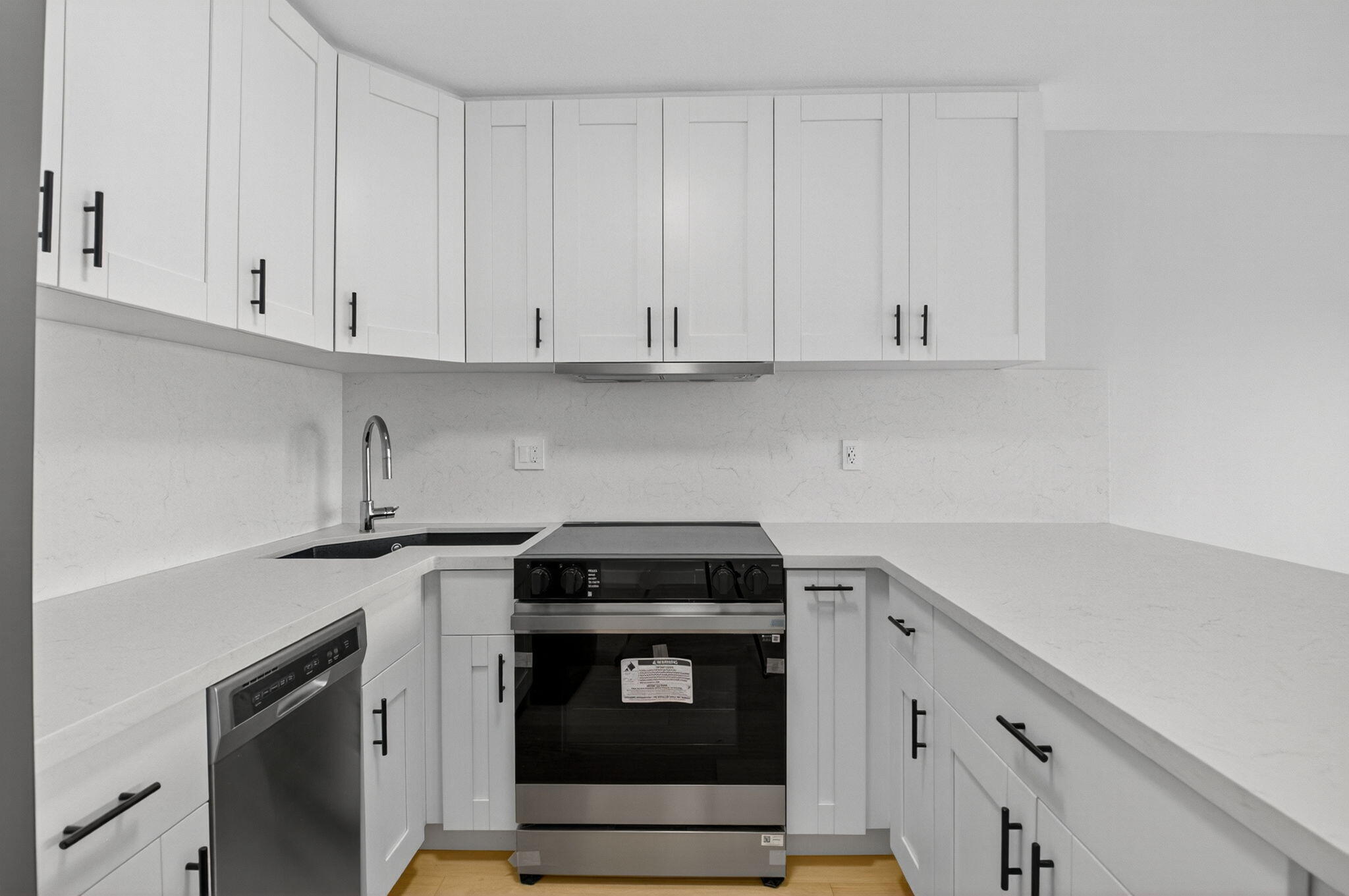 2871 North Ocean Boulevard, Unit V543 Boca Raton, FL 33431 - Photo 11 of 62 a kitchen with granite countertop white cabinets and a stove