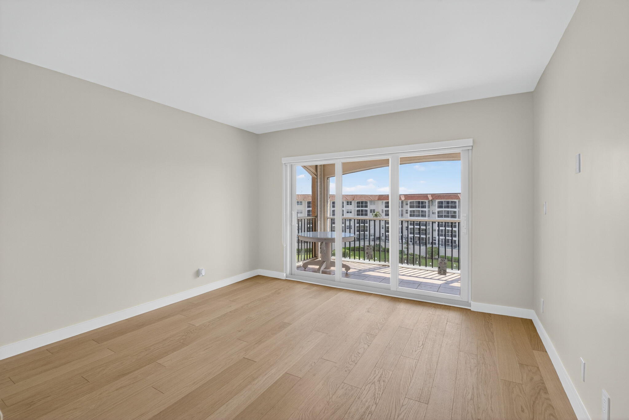 2871 North Ocean Boulevard, Unit V543 Boca Raton, FL 33431 - Photo 13 of 62 wooden floor in an empty room with a window