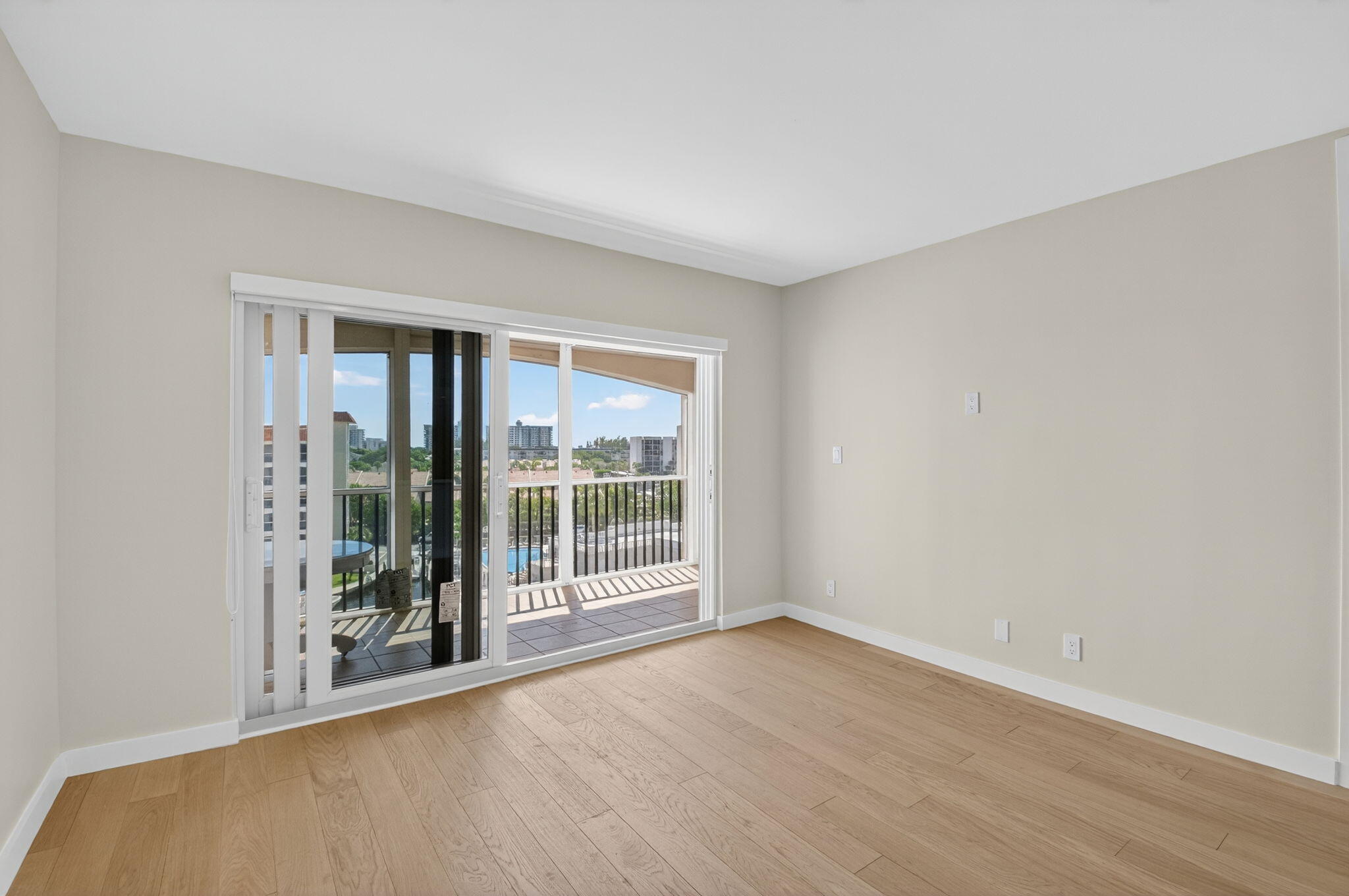 2871 North Ocean Boulevard, Unit V543 Boca Raton, FL 33431 - Photo 16 of 62 an empty room with wooden floor and windows