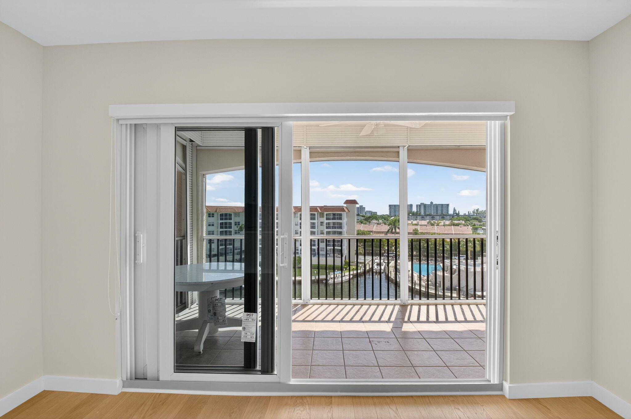 2871 North Ocean Boulevard, Unit V543 Boca Raton, FL 33431 - Photo 17 of 62 an empty room with wooden floor and a floor to ceiling window