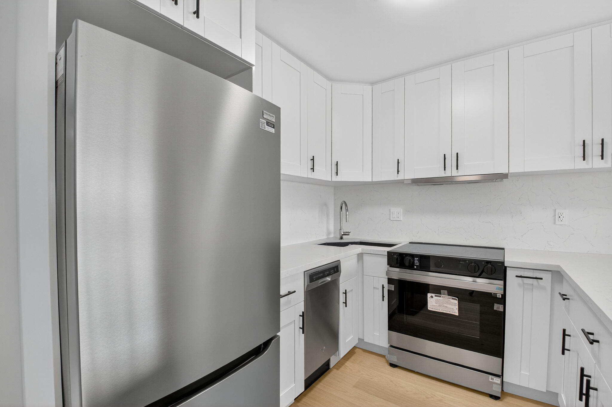 2871 North Ocean Boulevard, Unit V543 Boca Raton, FL 33431 - Photo 9 of 62 a kitchen with white cabinets and stainless steel appliances