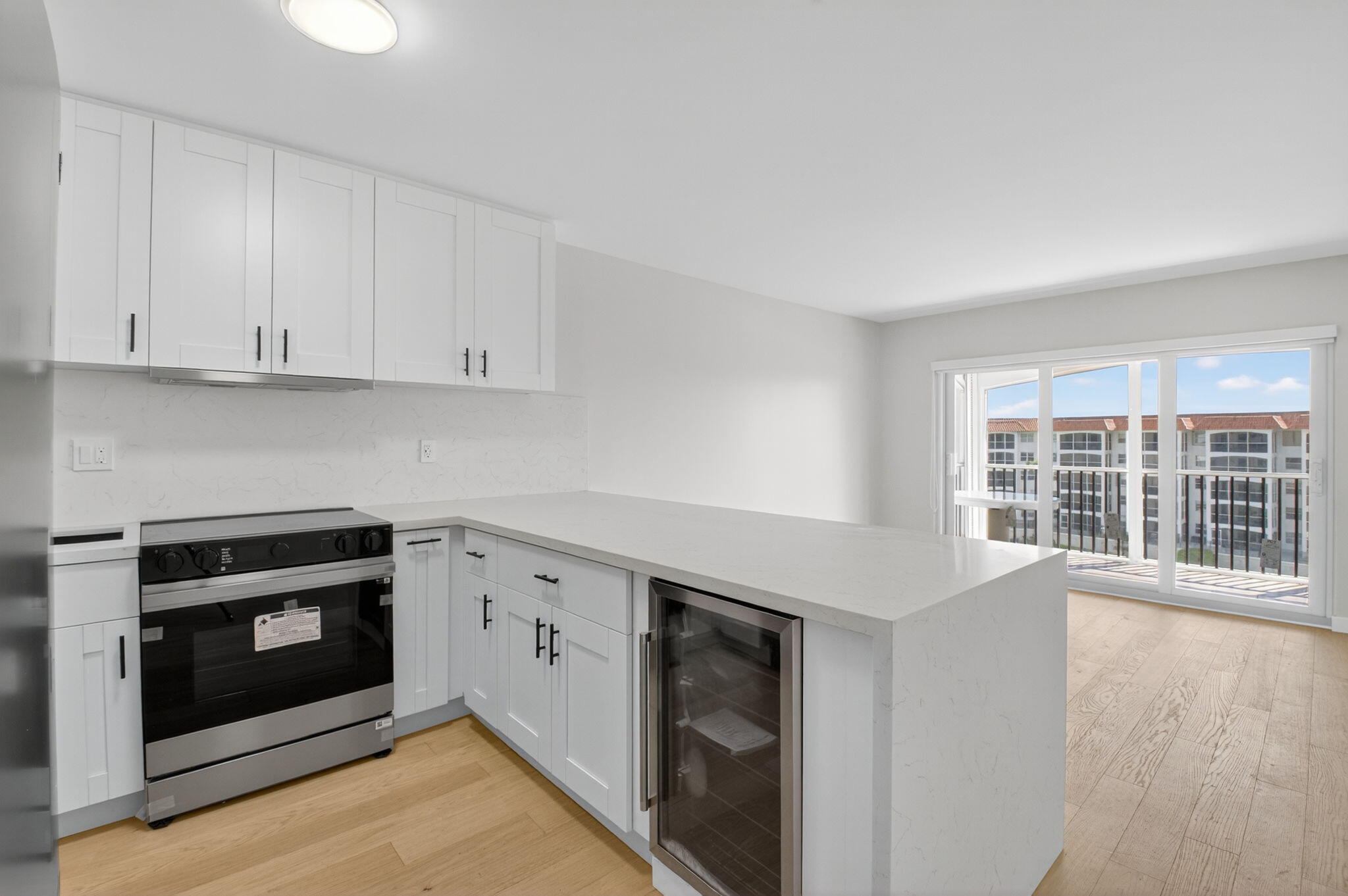 2871 North Ocean Boulevard, Unit V543 Boca Raton, FL 33431 - Photo 10 of 62 a kitchen with stainless steel appliances granite countertop a stove a microwave and a white cabinets