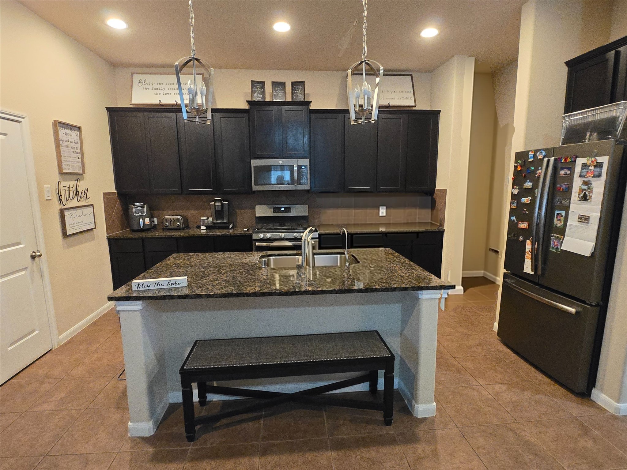 17451 Farm Pasture Trail Hockley, TX 77447 - Photo 27 of 27 a kitchen with stainless steel appliances granite countertop a sink refrigerator and microwave