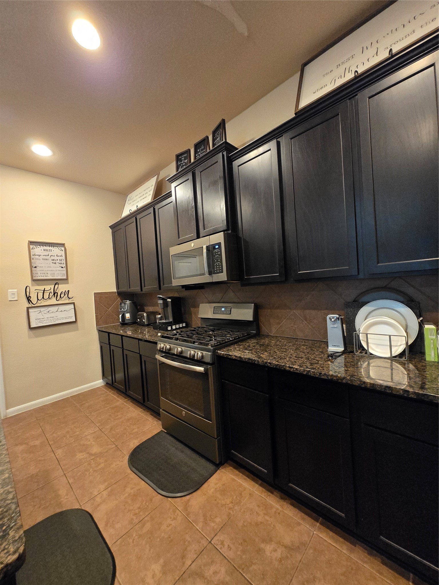 17451 Farm Pasture Trail Hockley, TX 77447 - Photo 4 of 27 a kitchen with stainless steel appliances granite countertop a stove a sink and a refrigerator
