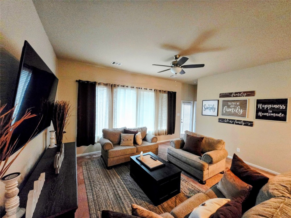 17451 Farm Pasture Trail Hockley, TX 77447 - Photo 8 of 27 a living room with furniture ceiling fan and a rug