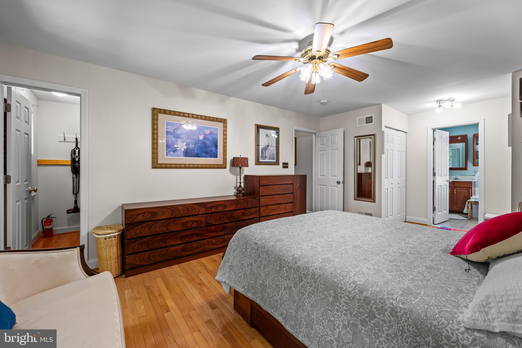 5026 Mt Carmel Road Hampstead, MD 21074 - Photo 27 of 57 a spacious bedroom with a bed and a chandelier