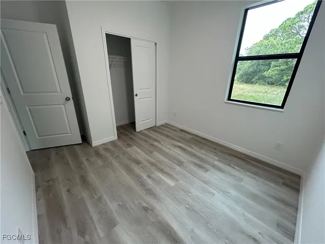 a view of a room with wooden floor and window