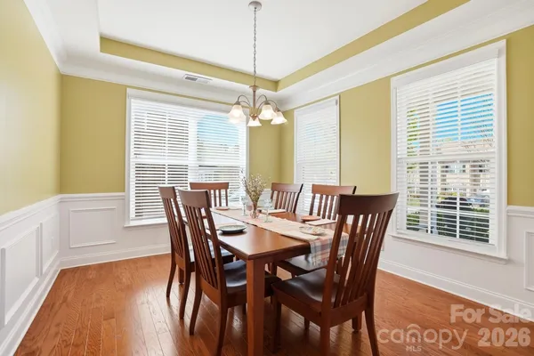 a view of a dining room with furniture and wooden floor