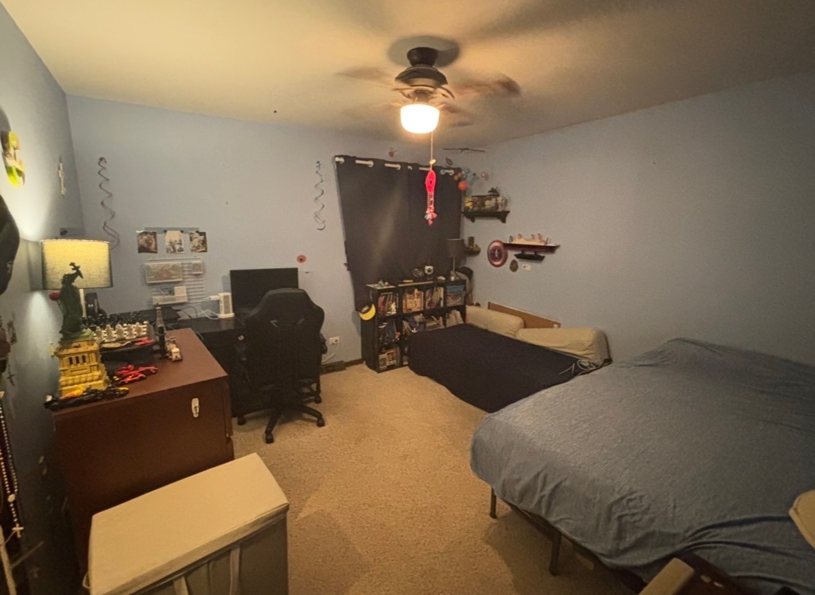 48 South Country Squire Road Palos Heights, IL 60463 - Photo 16 of 23 a bedroom with a bed and a chandelier