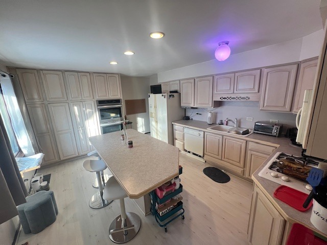 48 South Country Squire Road Palos Heights, IL 60463 - Photo 4 of 23 a kitchen with kitchen island a stove a sink cabinets and wooden floor