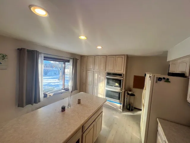 a spacious bathroom with a tub sink and a window