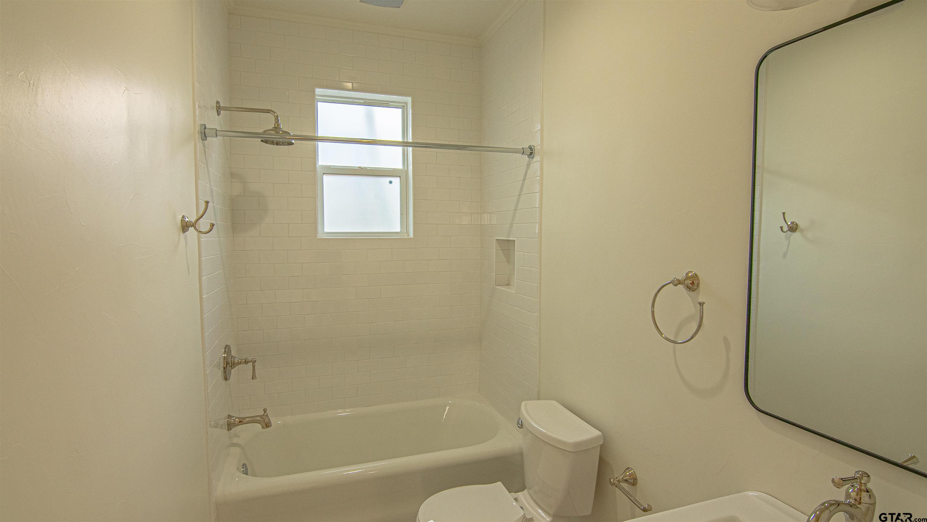 820 South Chilton Avenue Tyler, TX 75701 - Photo 11 of 20 a bathroom with a granite countertop toilet and a bathtub
