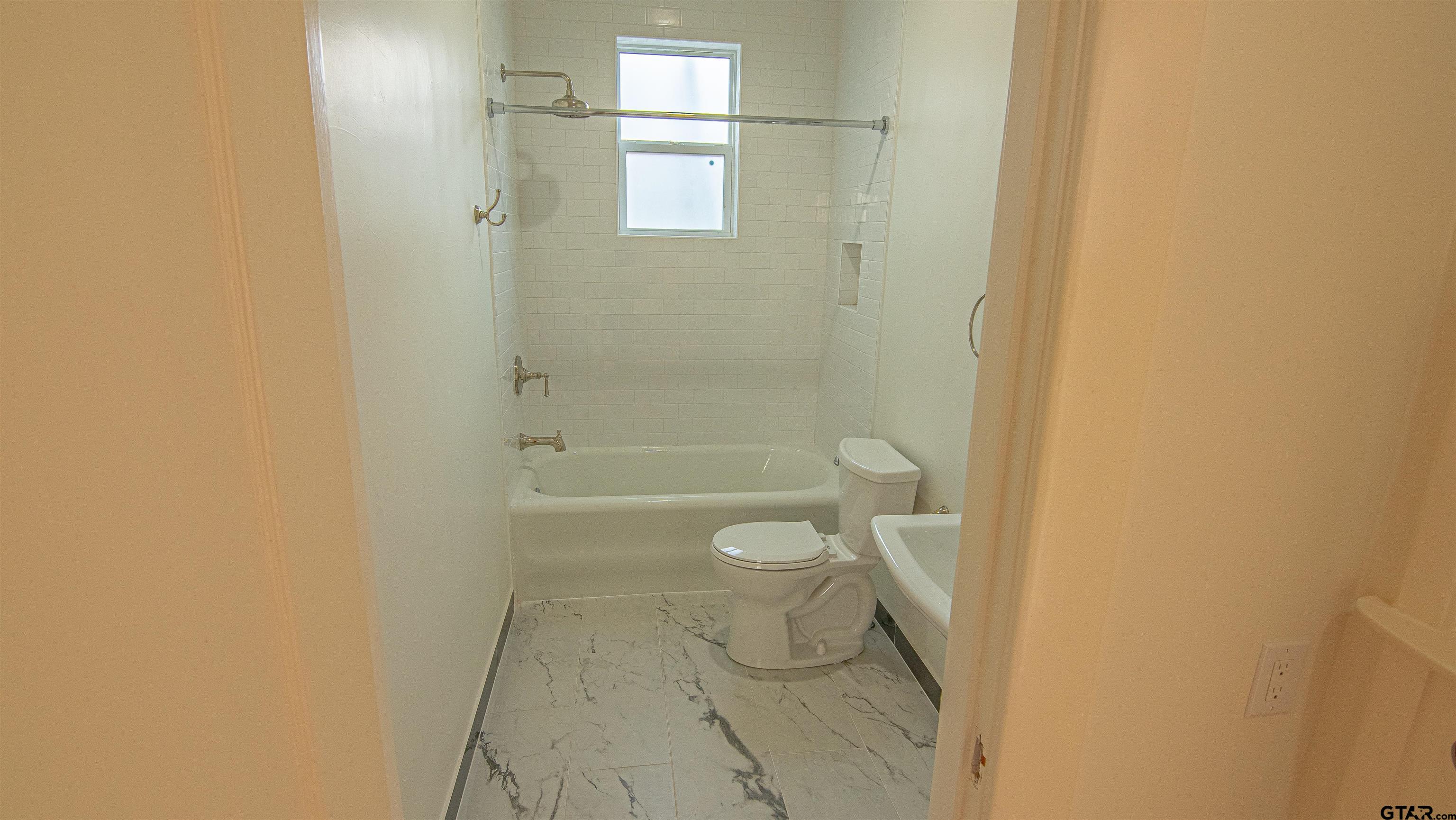 820 South Chilton Avenue Tyler, TX 75701 - Photo 12 of 20 a bathroom with a granite countertop toilet and a shower