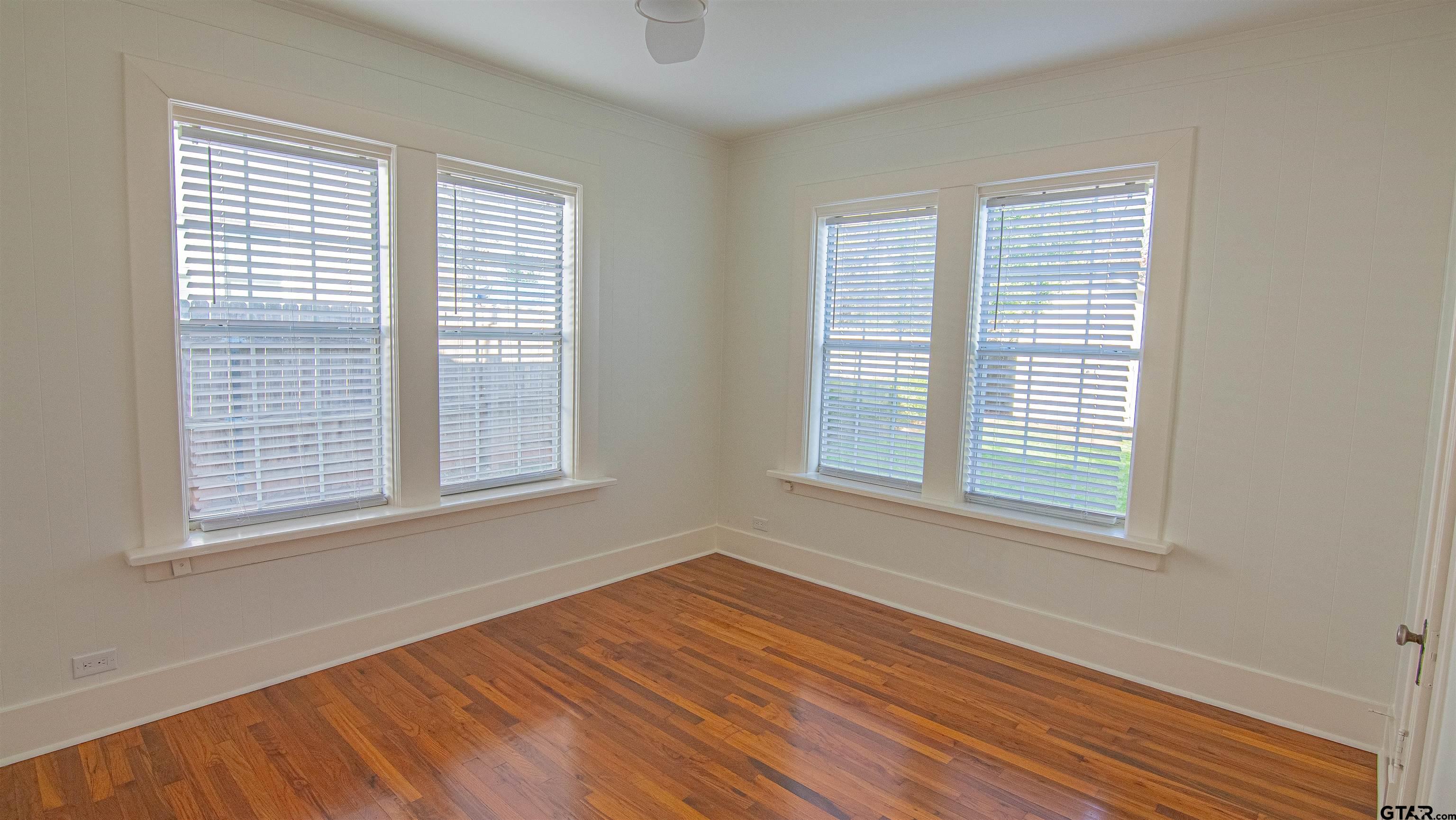 820 South Chilton Avenue Tyler, TX 75701 - Photo 13 of 20 a view of an empty room with wooden floor and a window