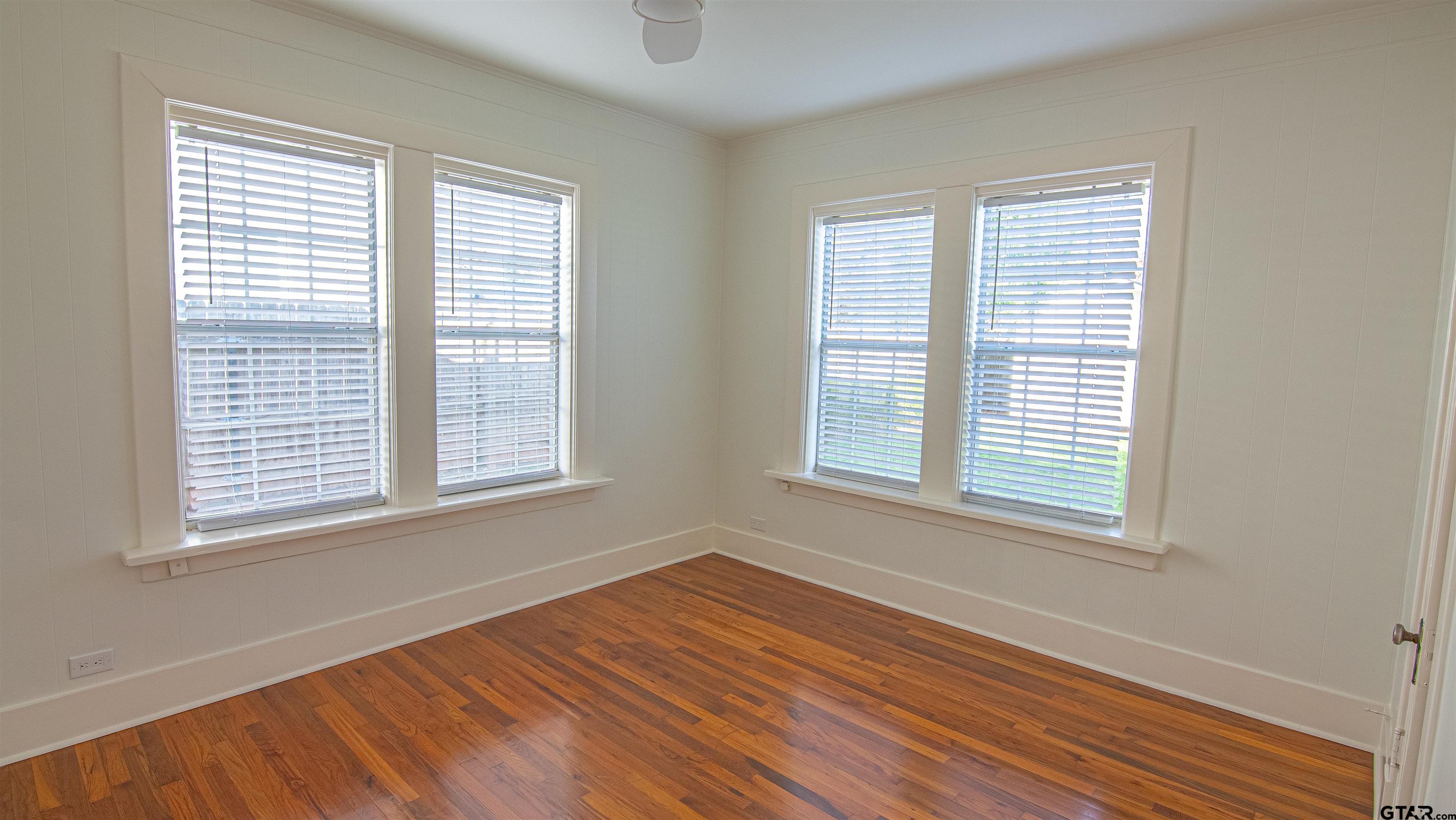 820 South Chilton Avenue Tyler, TX 75701 - Photo 15 of 20 a view of an empty room with wooden floor and a window