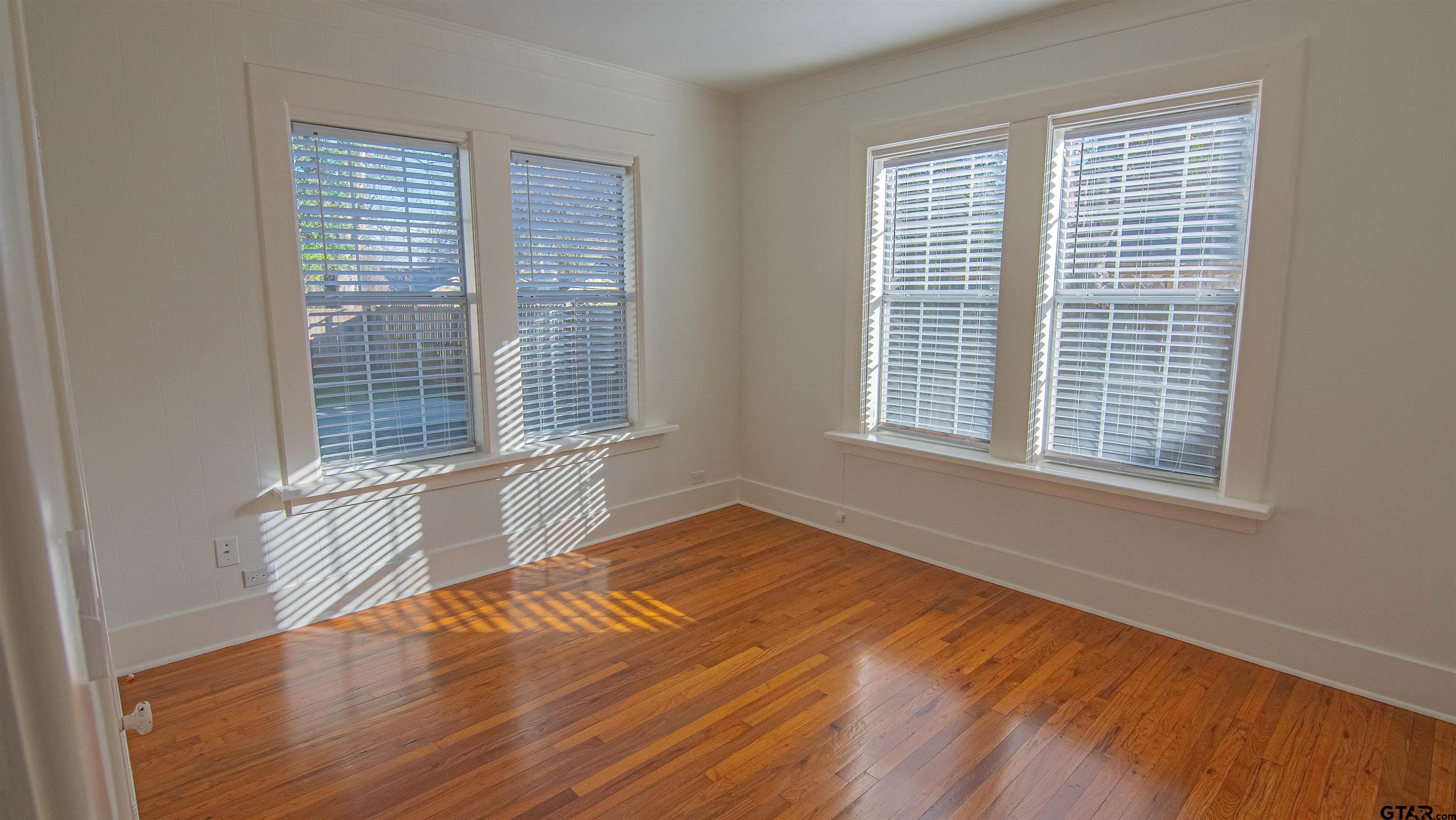 820 South Chilton Avenue Tyler, TX 75701 - Photo 16 of 20 a view of an empty room with wooden floor and a window