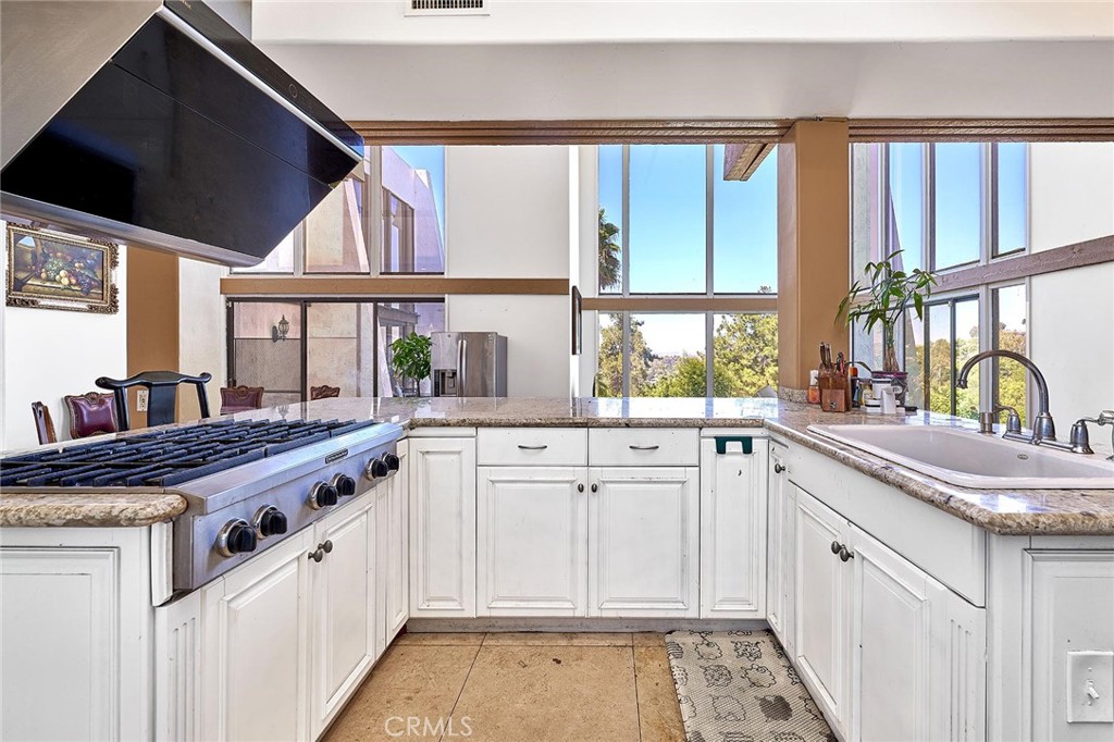 22702 Timbertop Lane Diamond Bar, CA 91765 - Photo 22 of 75 a kitchen with granite countertop a sink and a large window