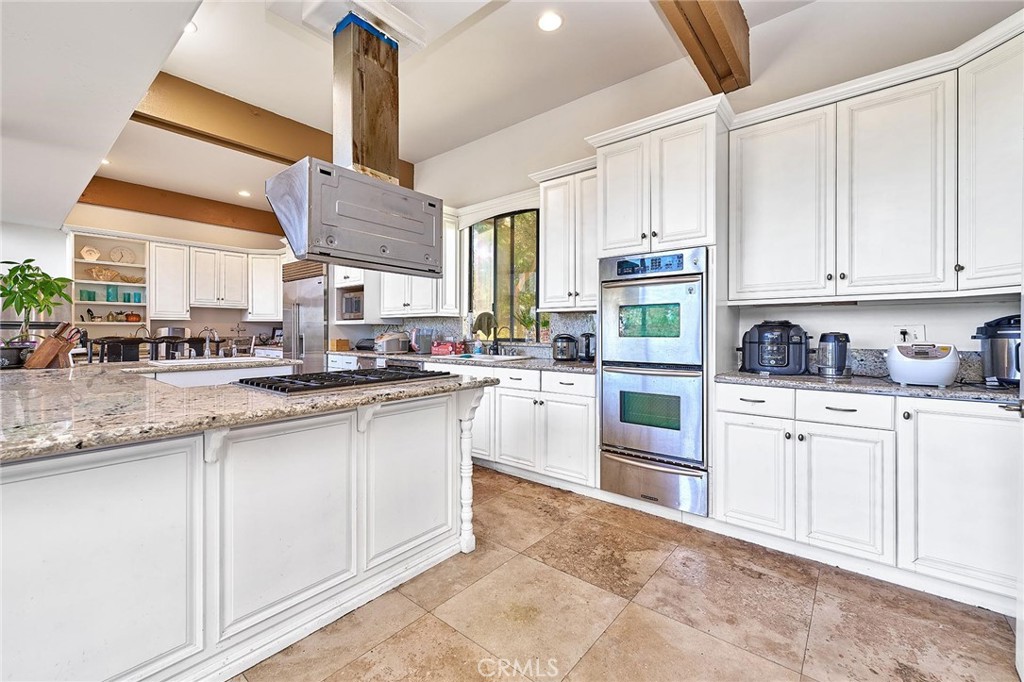 22702 Timbertop Lane Diamond Bar, CA 91765 - Photo 24 of 75 a kitchen with stainless steel appliances granite countertop a sink and cabinets