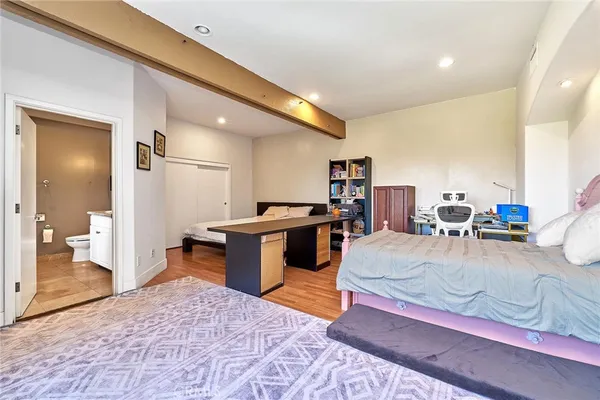 a living room with furniture a flat screen tv and a large window