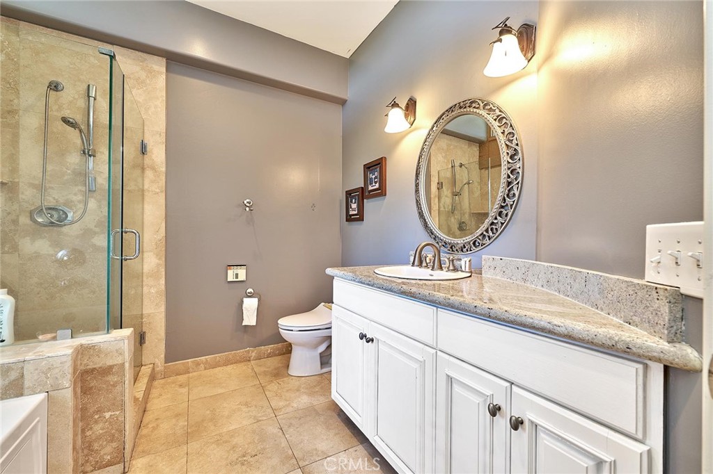 22702 Timbertop Lane Diamond Bar, CA 91765 - Photo 32 of 75 a bathroom with a toilet a sink and mirror