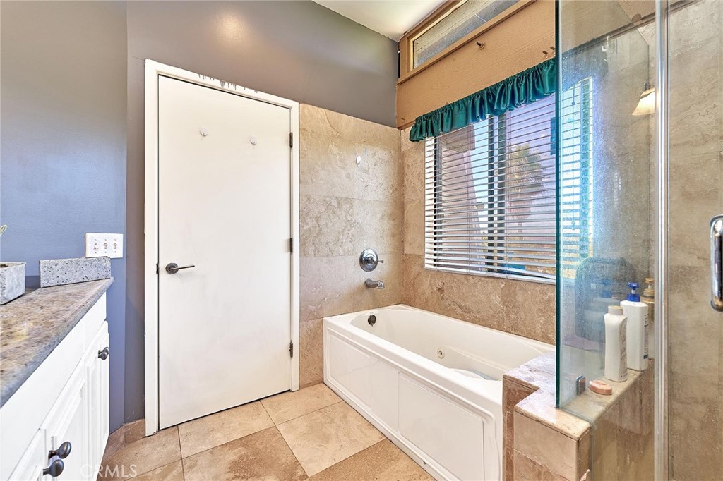 22702 Timbertop Lane Diamond Bar, CA 91765 - Photo 35 of 75 a bathroom with a granite countertop tub shower and sink