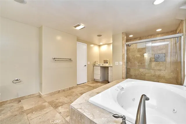 a bathroom with a glass shower door