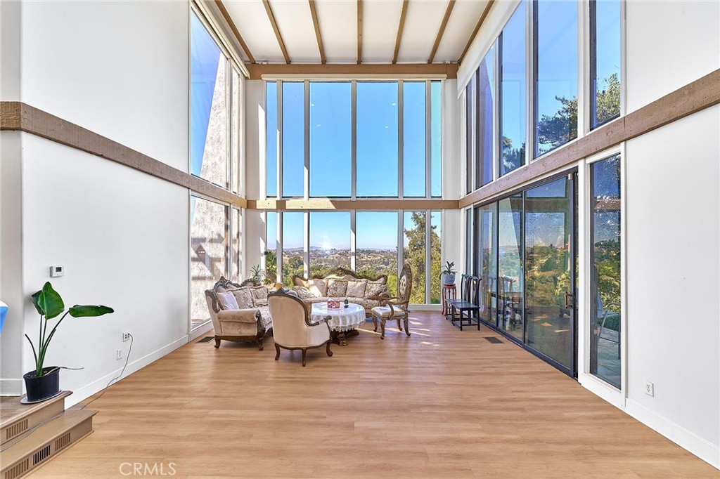22702 Timbertop Lane Diamond Bar, CA 91765 - Photo 5 of 75 a living room with furniture floor to ceiling window and wooden floor