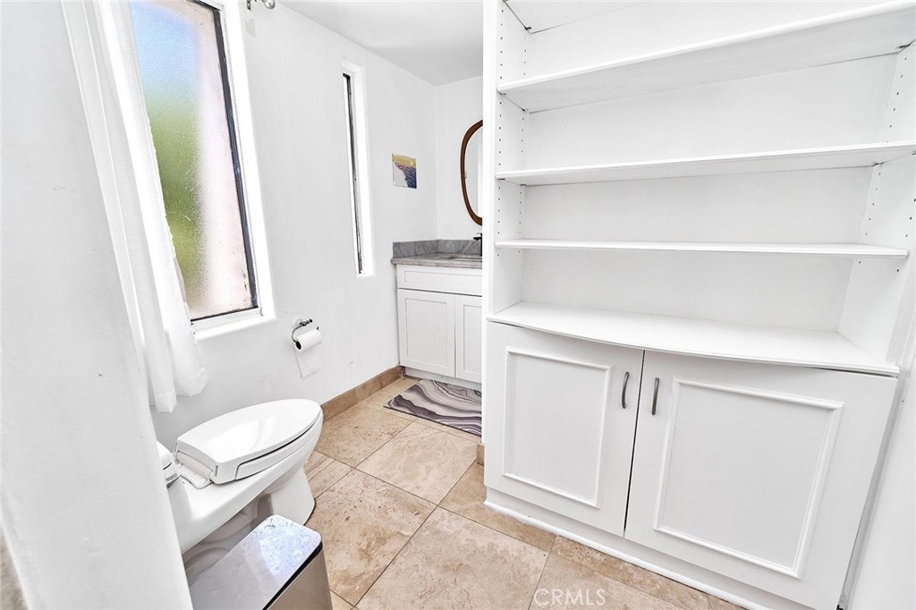 22702 Timbertop Lane Diamond Bar, CA 91765 - Photo 51 of 75 a bathroom with a granite countertop sink a toilet and a mirror