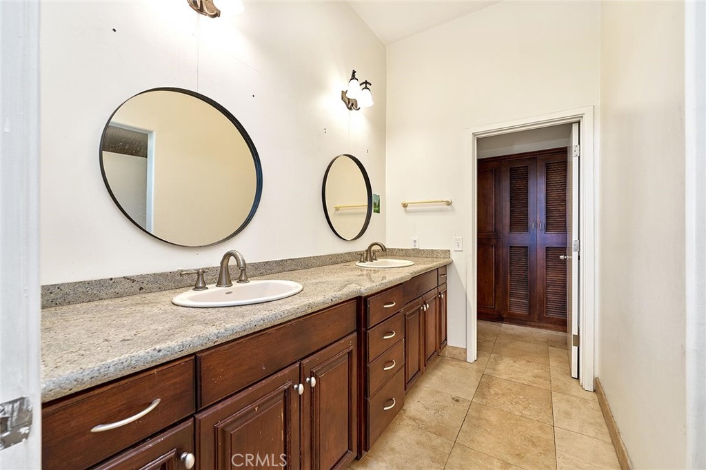 22702 Timbertop Lane Diamond Bar, CA 91765 - Photo 55 of 75 a bathroom with a granite countertop sink and a mirror