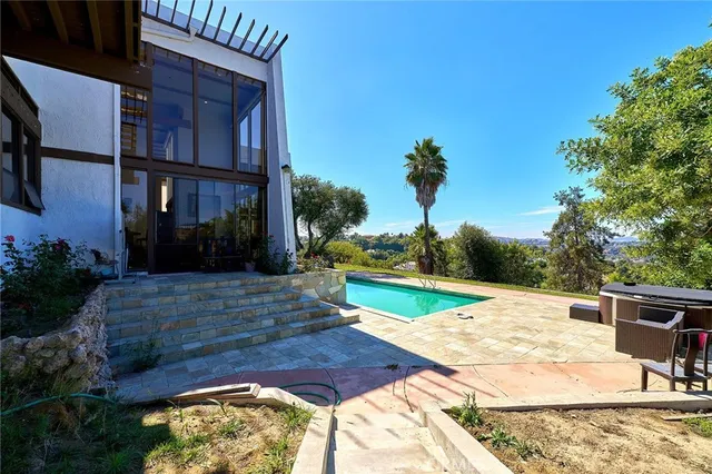 a living room filled with furniture and a large window