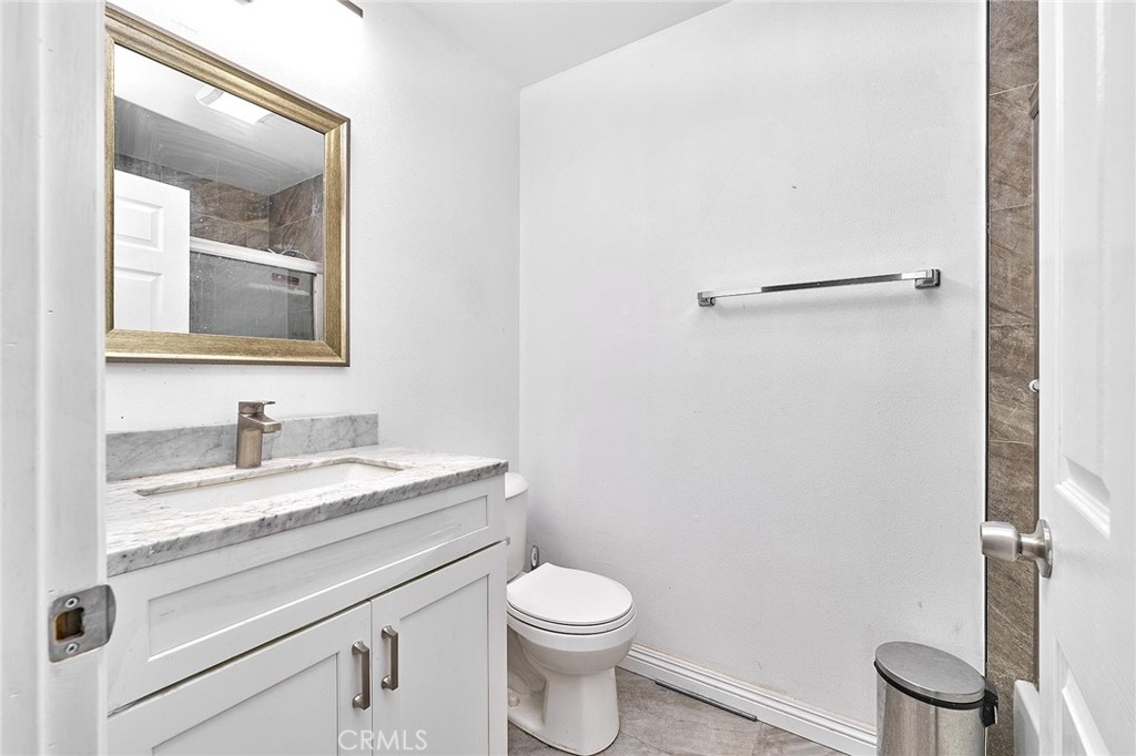 22702 Timbertop Lane Diamond Bar, CA 91765 - Photo 63 of 75 a bathroom with a granite countertop toilet sink mirror and vanity