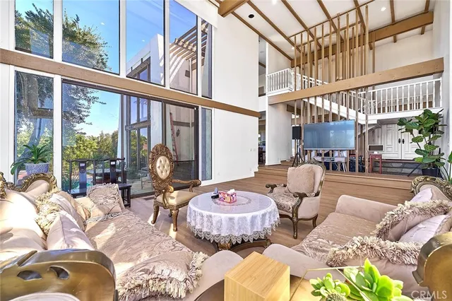 a living room filled with furniture and a large window