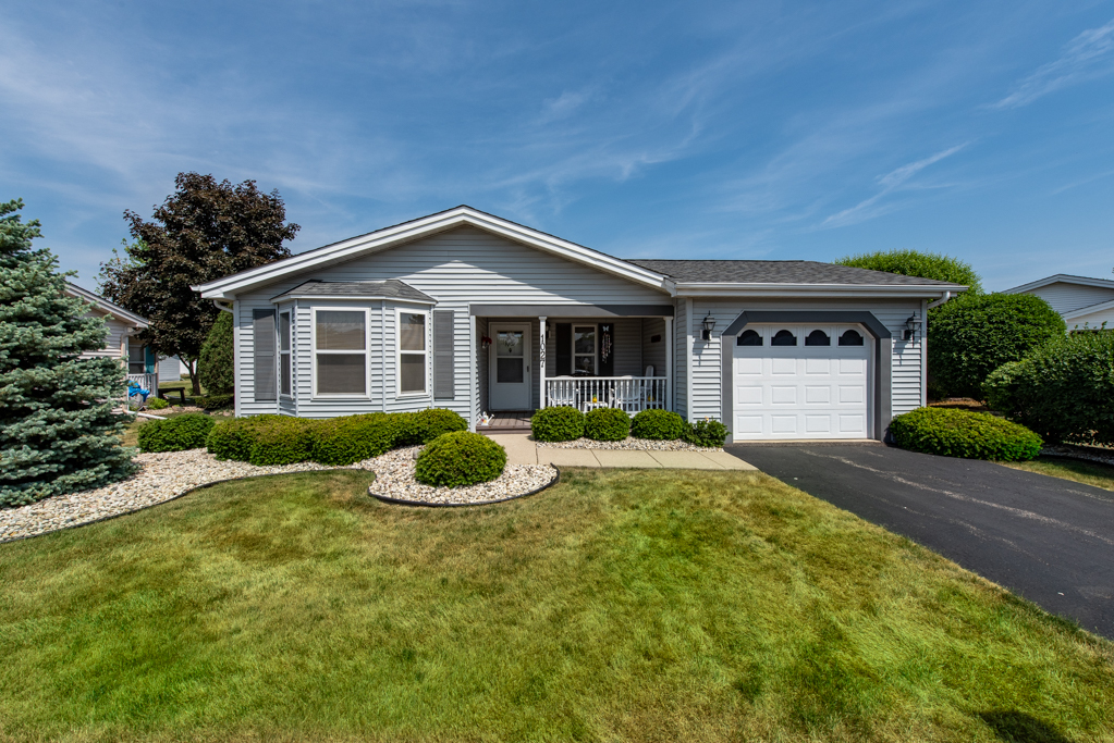 a front view of a house with yard and porch