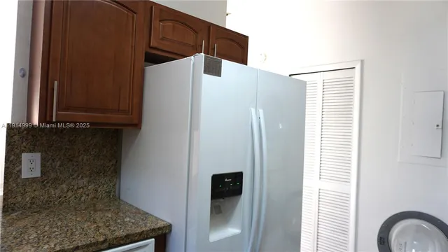 a white refrigerator freezer sitting in a kitchen
