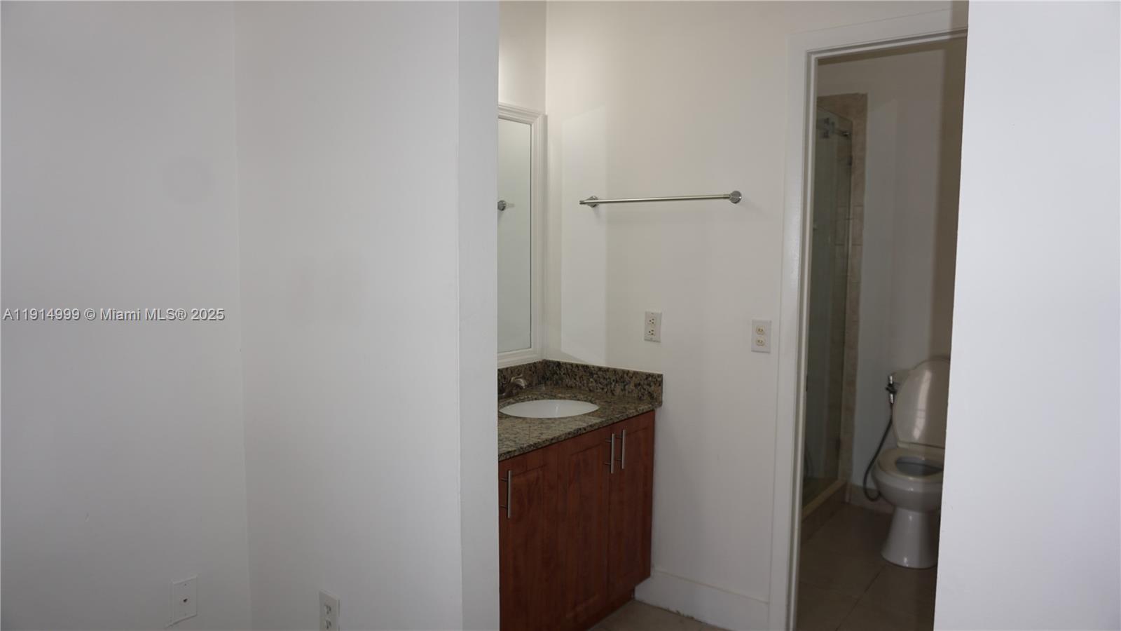 13479 Southwest 62nd Street Miami, FL 33183 - Photo 15 of 27 a bathroom with a granite countertop sink and vanity