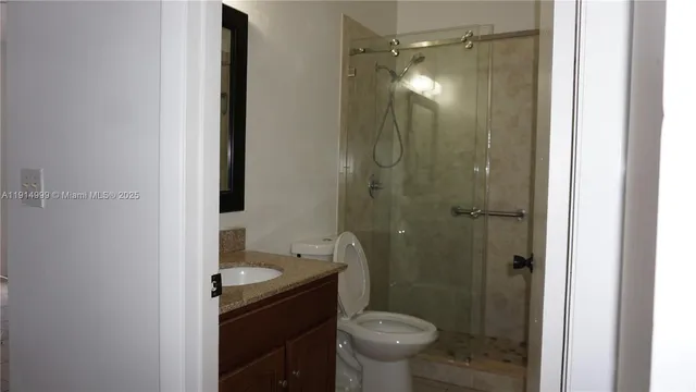 a bathroom with a shower and a toilet