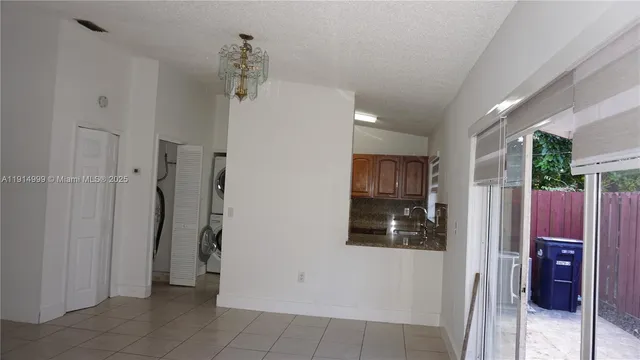 a view of a hallway with closet and a bathroom